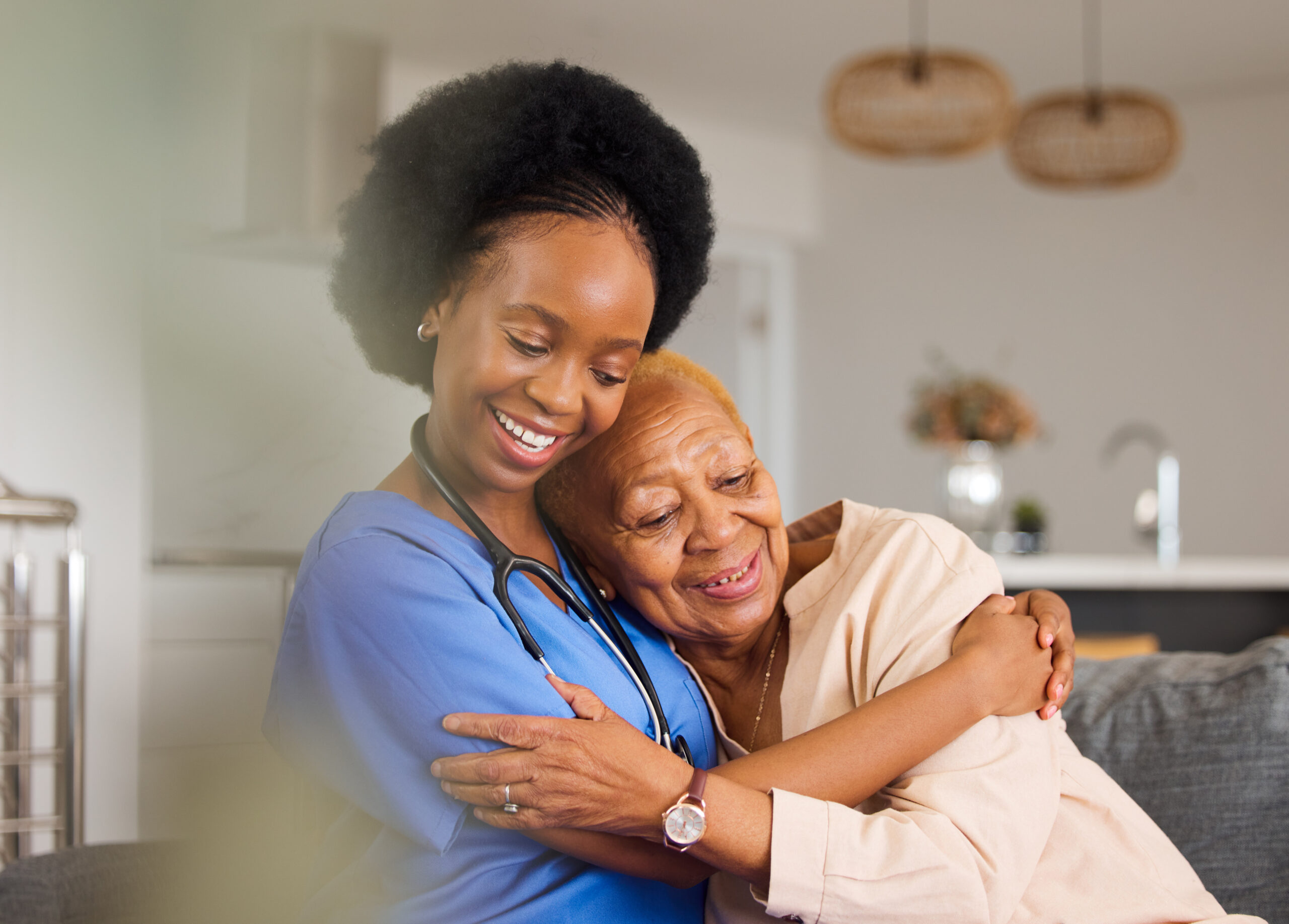 Health care black people, hug and nurse in elderly care for support, trust or healthcare in old age home. happy african female person, caregiver or medical professional with senior patient in retirement on sofa
